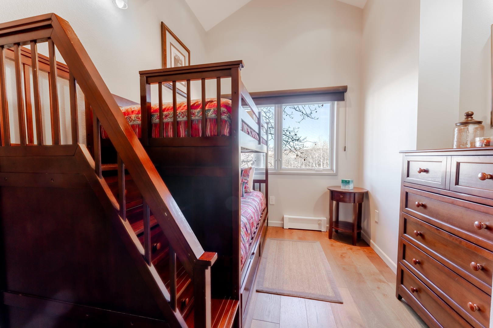 Your cozy retreat features handcrafted bunk beds with warm wood tones, perfect for families or friends sharing memories together.