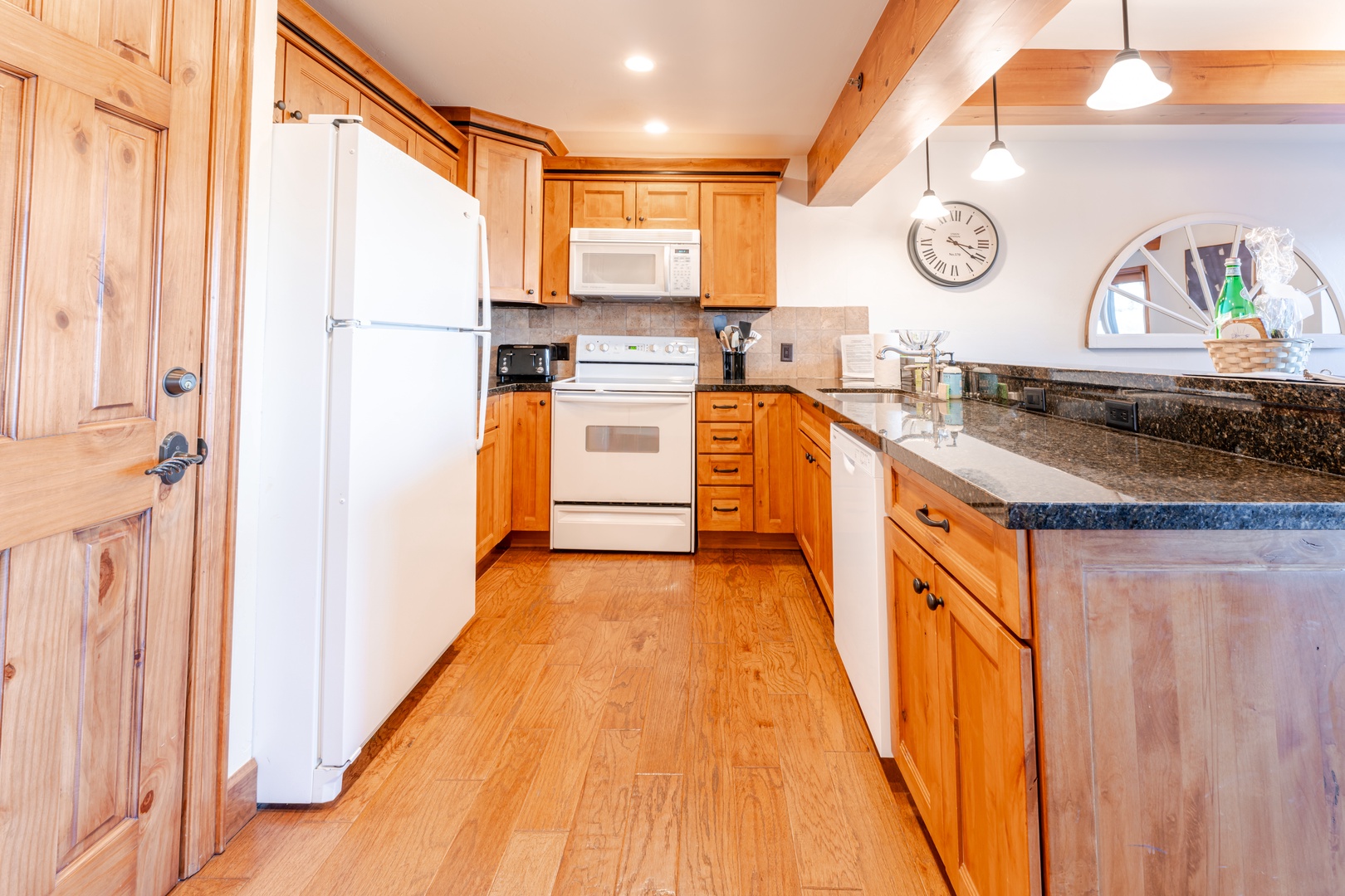 Your fully equipped kitchen features warm wood cabinetry, granite countertops, and all appliances needed for memorable meals together.