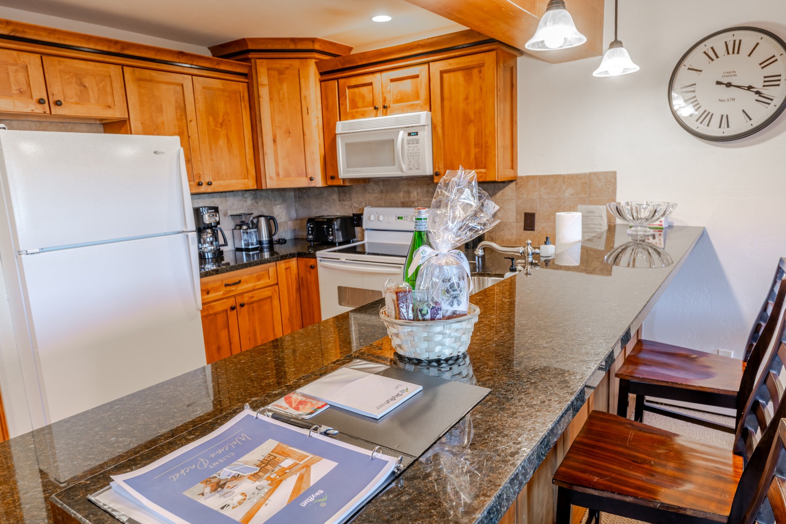 Your fully equipped kitchen features granite counters, warm wood cabinets, and modern appliances—perfect for preparing meals during your stay.