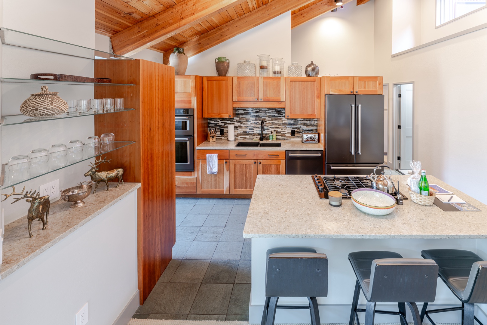 Your spacious kitchen welcomes you with warm wood cabinetry, granite countertops, and modern appliances perfect for preparing memorable meals.