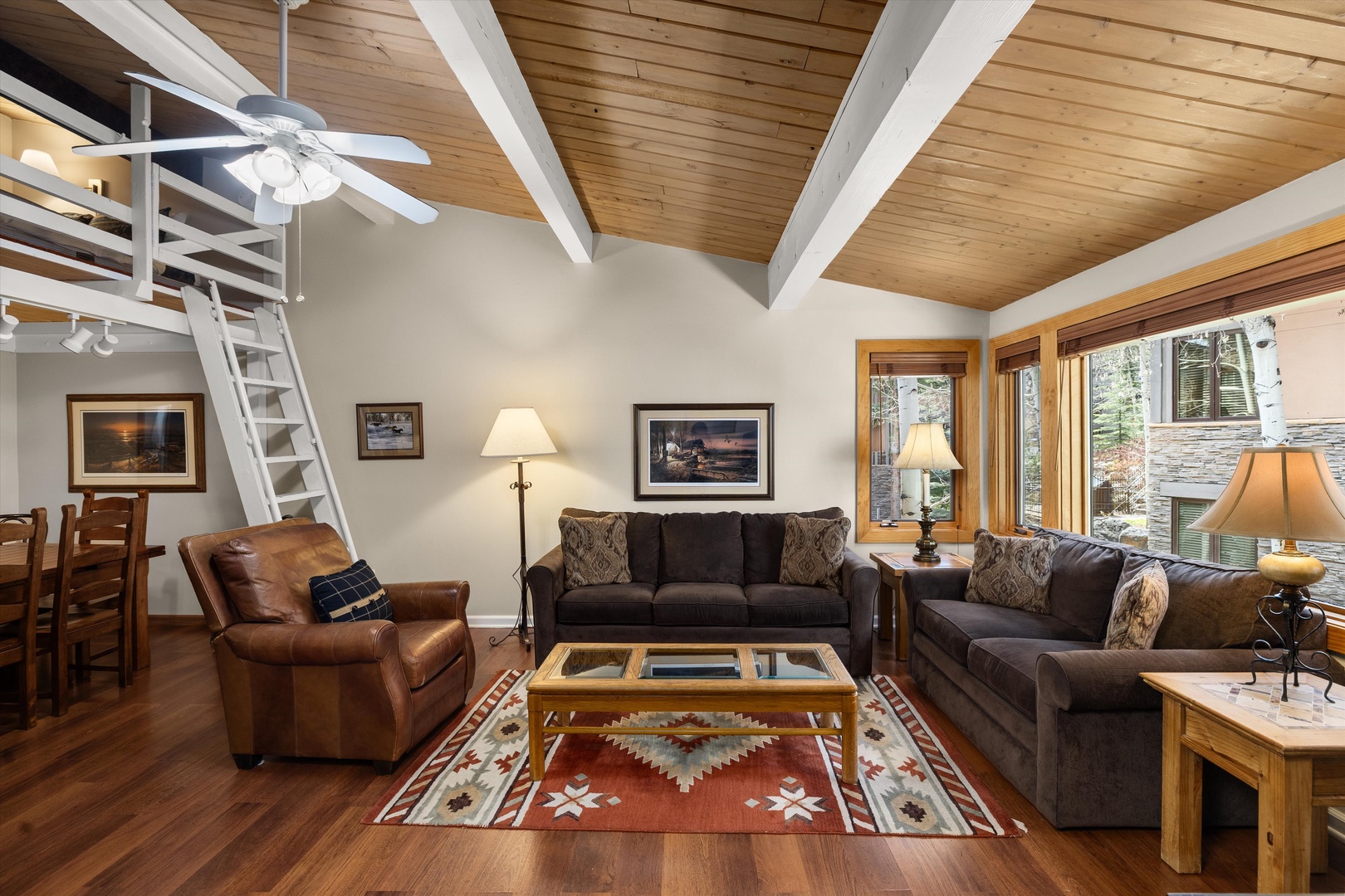 Relax beneath vaulted wood ceilings where leather seating and warm lighting create your perfect mountain retreat sanctuary.