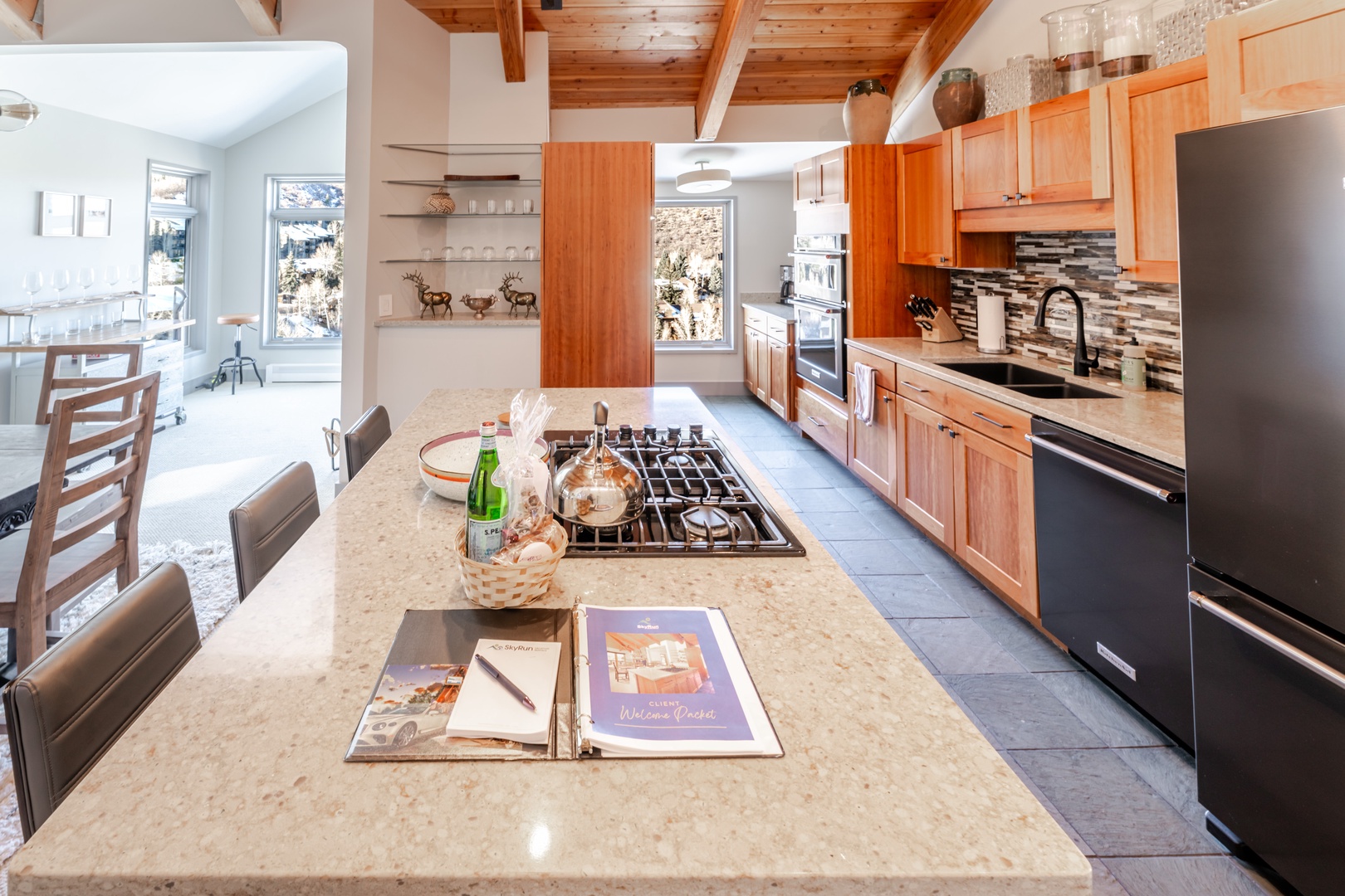 You'll love creating culinary memories in this gourmet kitchen featuring warm wood cabinetry, granite countertops, and top-tier appliances.