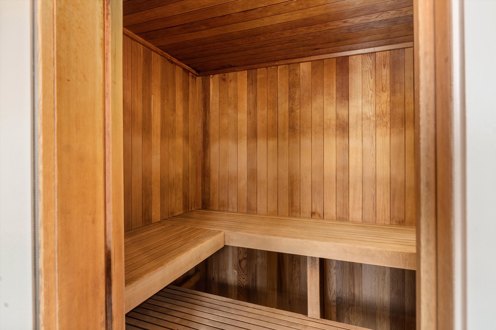 Step into your private sauna and feel tension melt away as warm cedar wood surrounds you in peaceful relaxation.