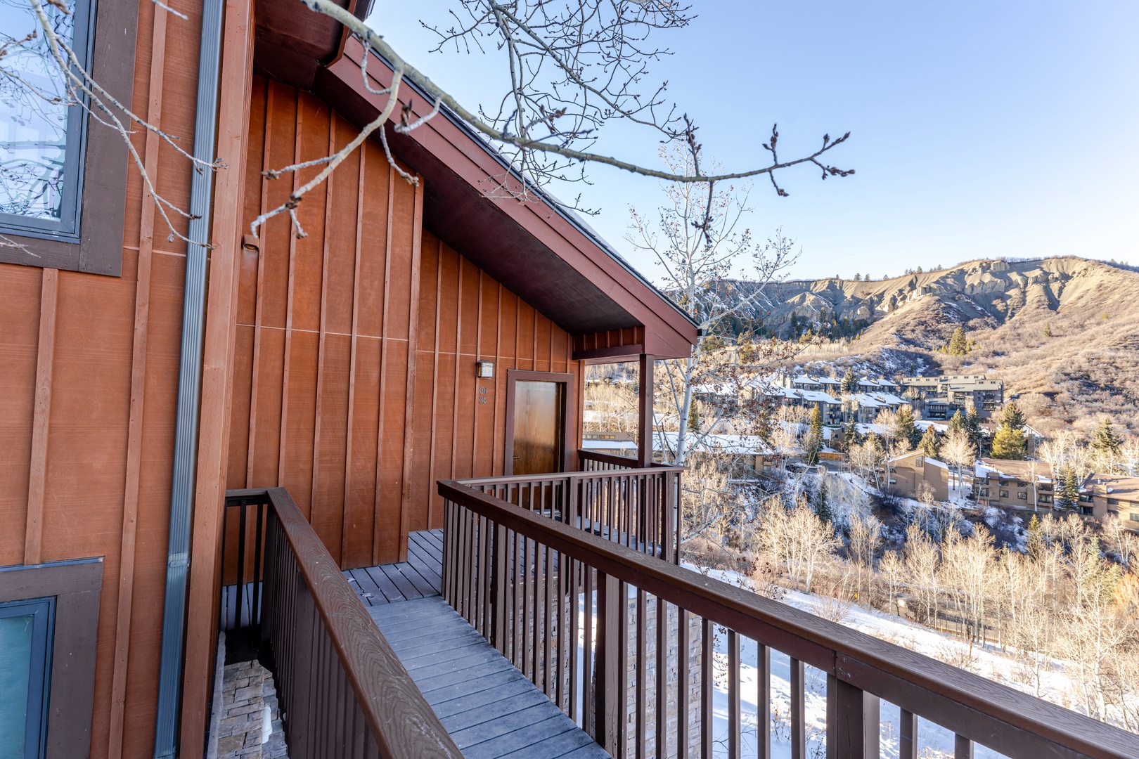 Mountain property exterior featuring wooden siding and scenic hillside surroundings.