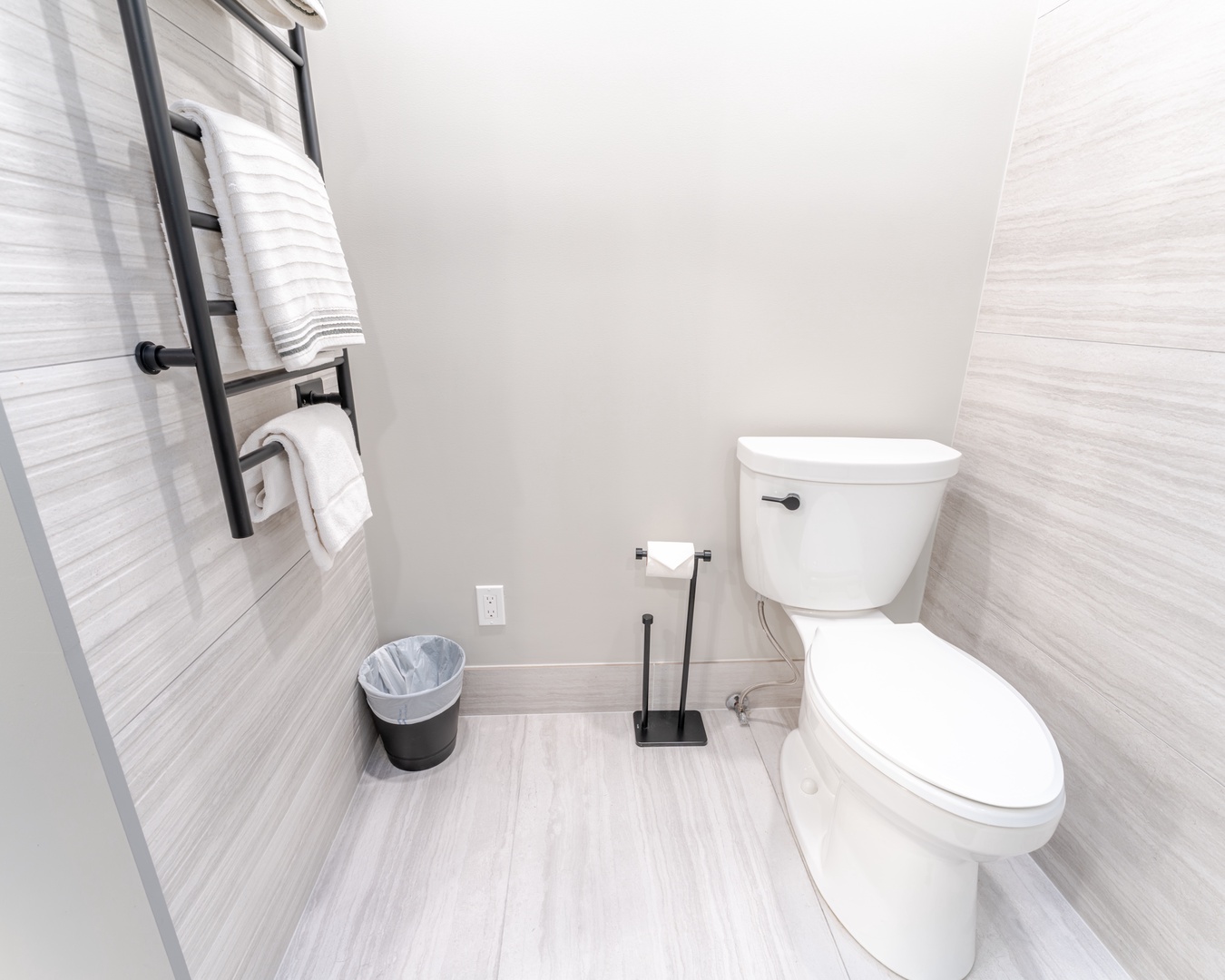 Your private bathroom features modern finishes and thoughtful touches, with fluffy towels and stylish tile work creating a serene space.