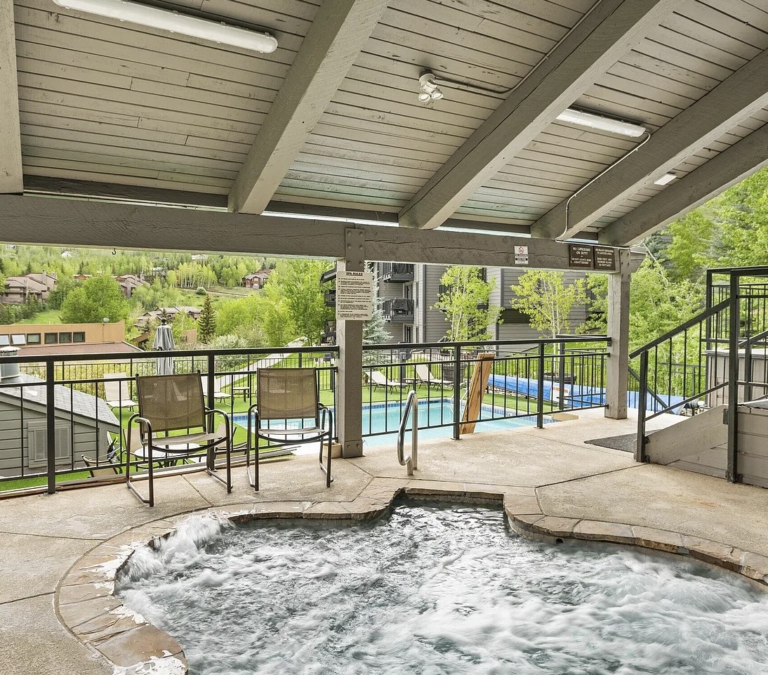 Soak away your worries in this bubbling hot tub with peaceful mountain views. The covered deck and nearby seating make it perfect for relaxing any time of day.