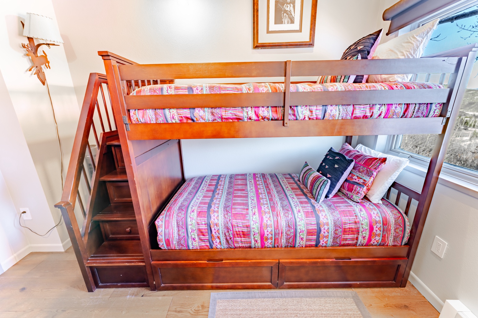 Your kids will love this cozy bunk bed with built-in storage stairs and colorful bedding in their own special room.