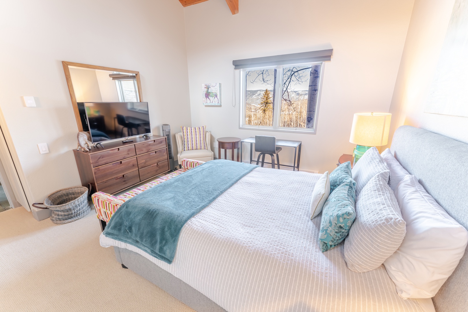 Rest peacefully in your cozy guest bedroom with plush linens, modern amenities, and stunning mountain views from your window.