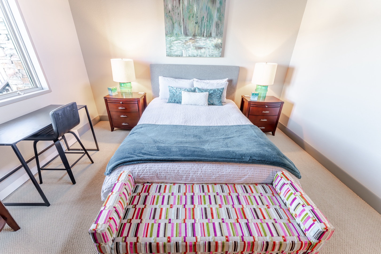 Drift into peaceful sleep in your elegant bedroom, where soft blue linens and warm bedside lighting create the perfect sanctuary for rest.