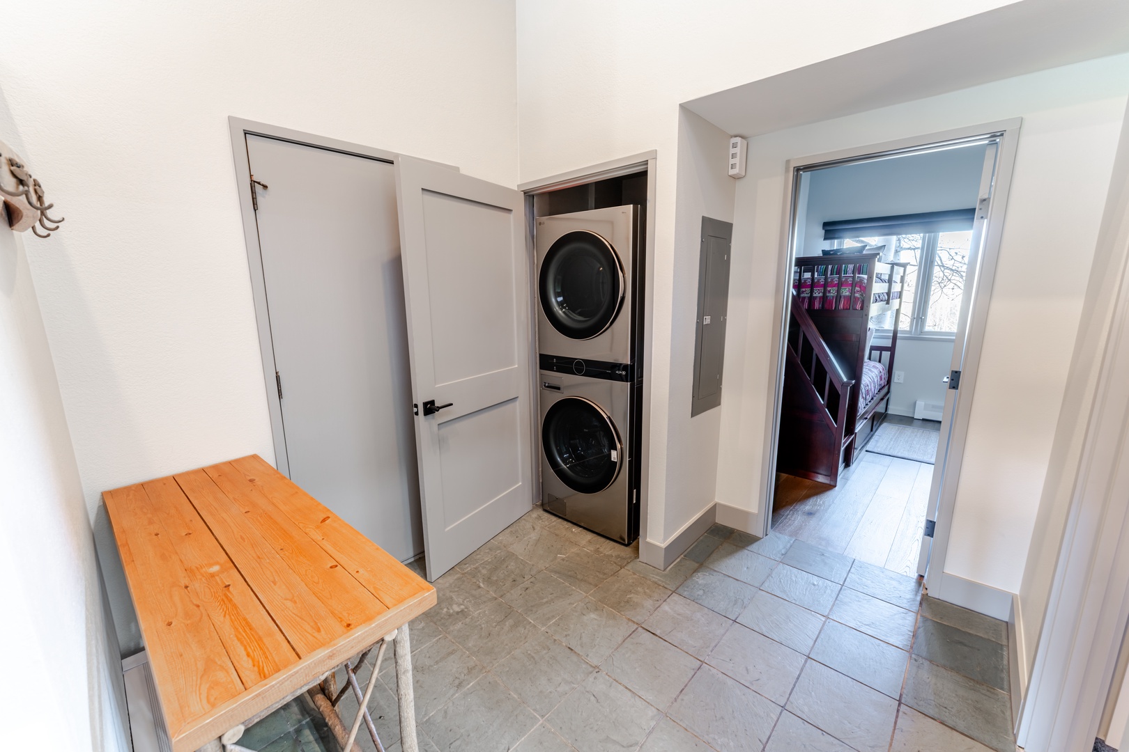 Your private laundry nook features stacked washer and dryer plus a handy folding table for effortless clothes care.