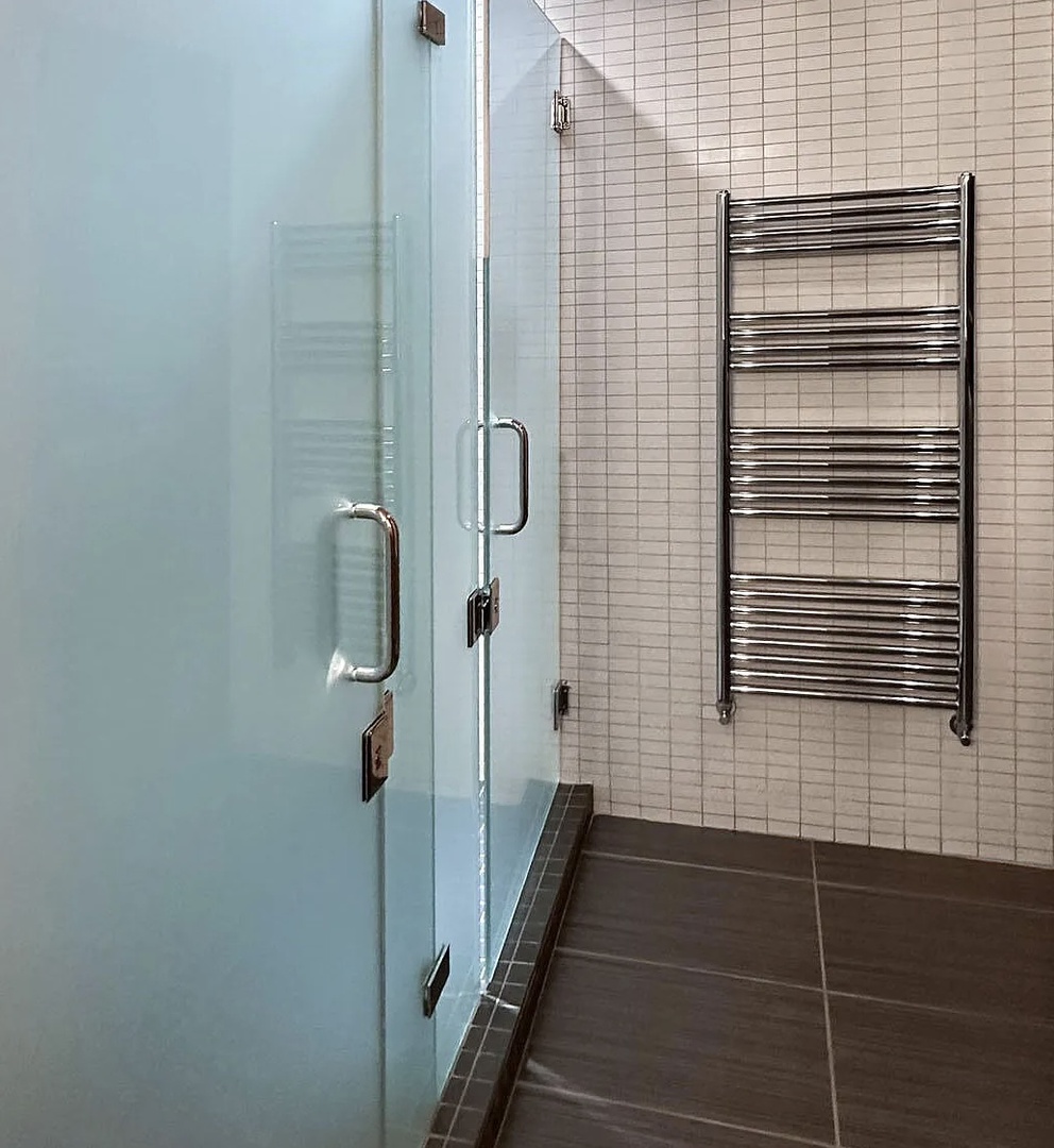 Step into this sleek, modern shower with glass doors and heated towel rail—designed for your ultimate comfort and convenience after a dip in the pool. Community Amenity.