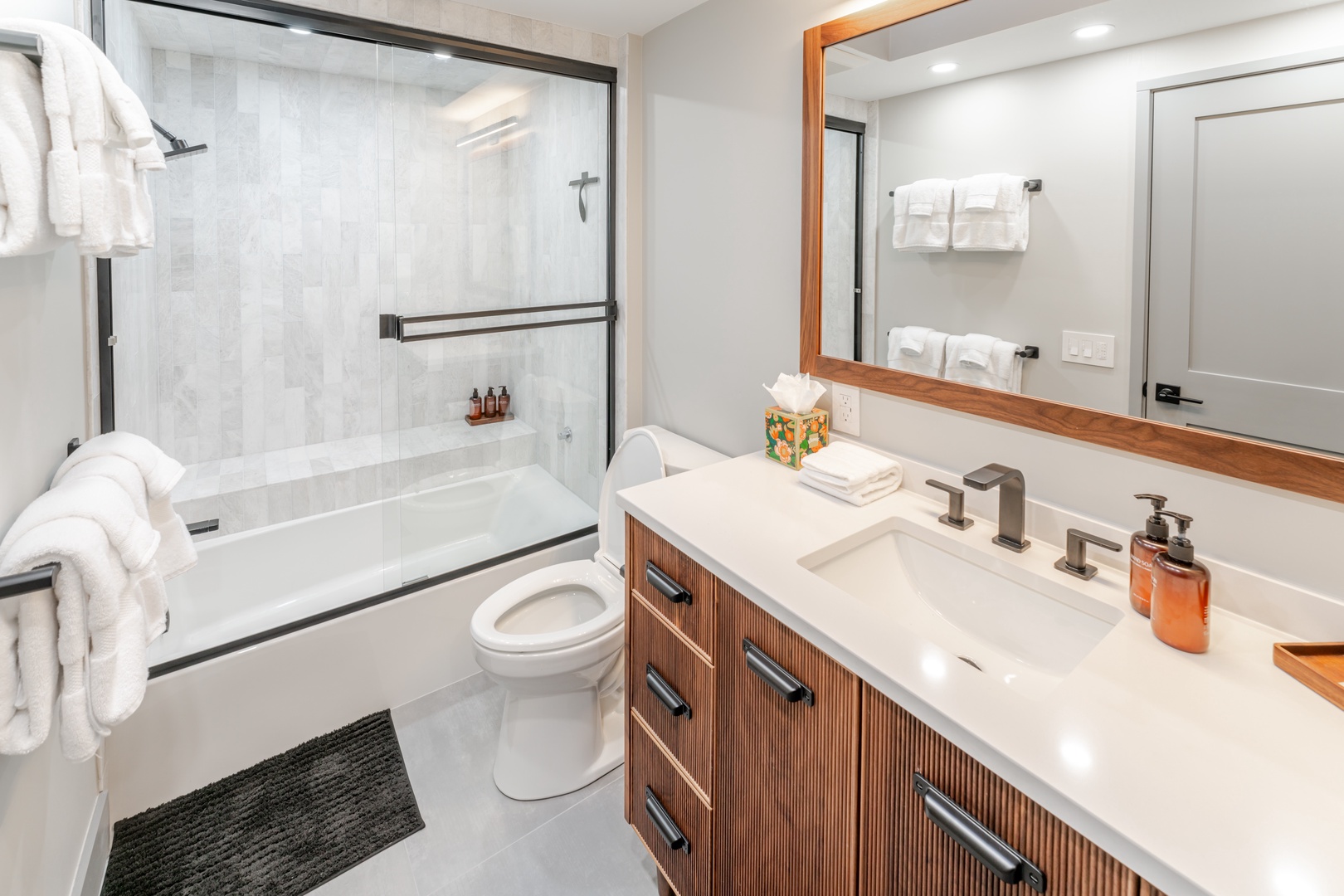 Refresh in your stylish guest bathroom featuring a soaking tub, walk-in shower, and premium amenities for ultimate comfort.