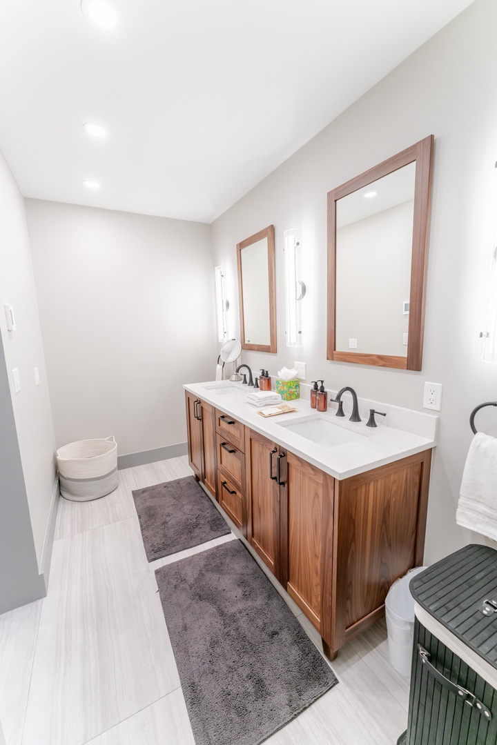 Unwind in your elegant bathroom with dual vanities, warm wood finishes, and luxurious amenities for a spa-like retreat.