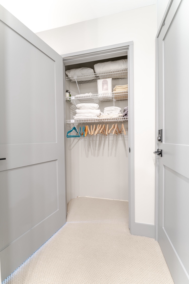 Your private walk-in closet features organized shelving and hanging space, plus fresh towels and linens ready for your stay.