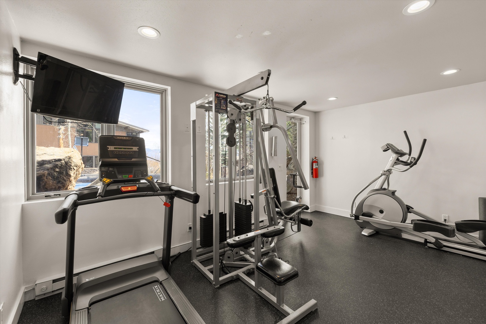Your private fitness center awaits with professional equipment and mountain views to inspire your daily workout routine.