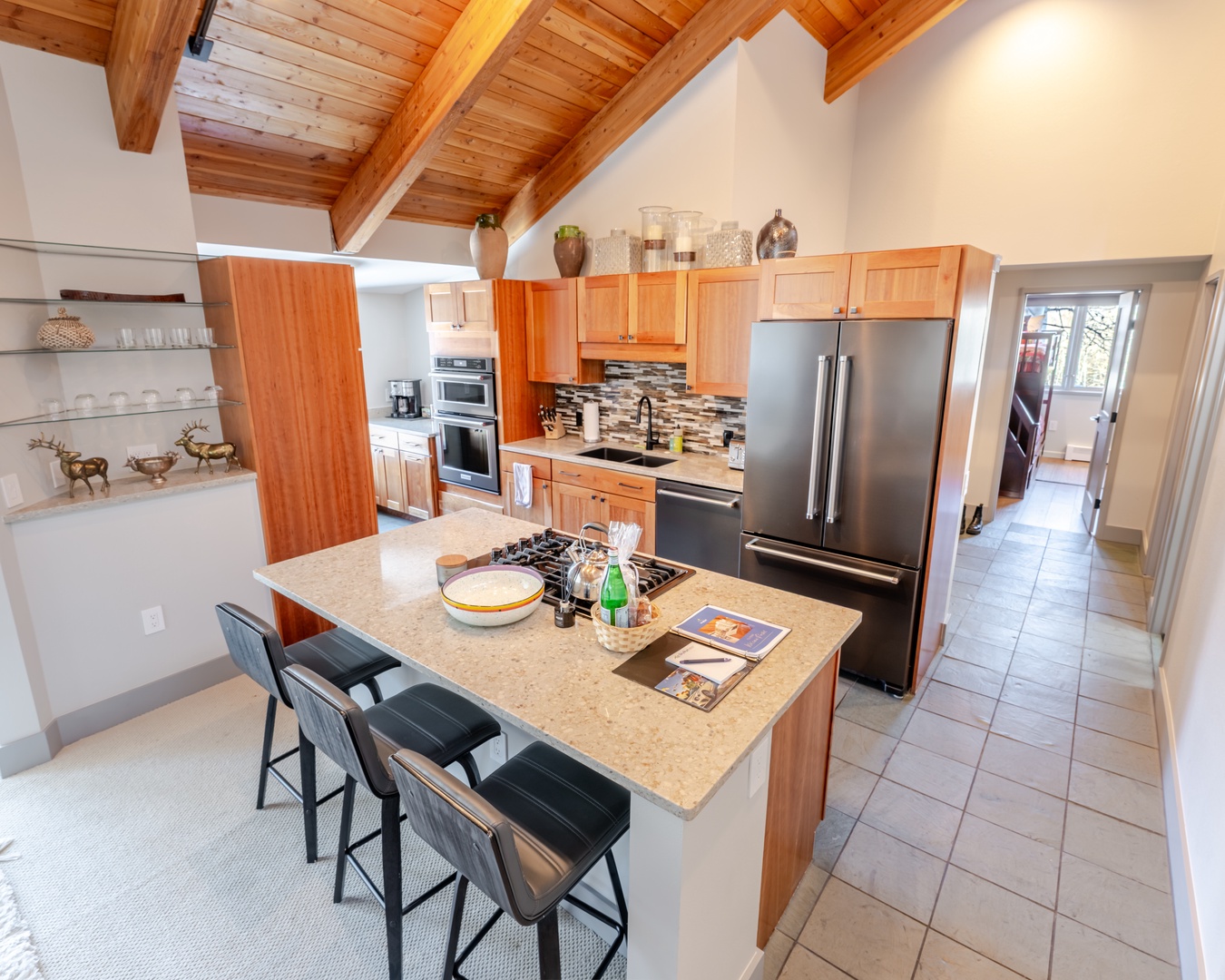 Your spacious gourmet kitchen invites you to create culinary masterpieces under stunning exposed beam ceilings, with modern appliances and a welcoming island.