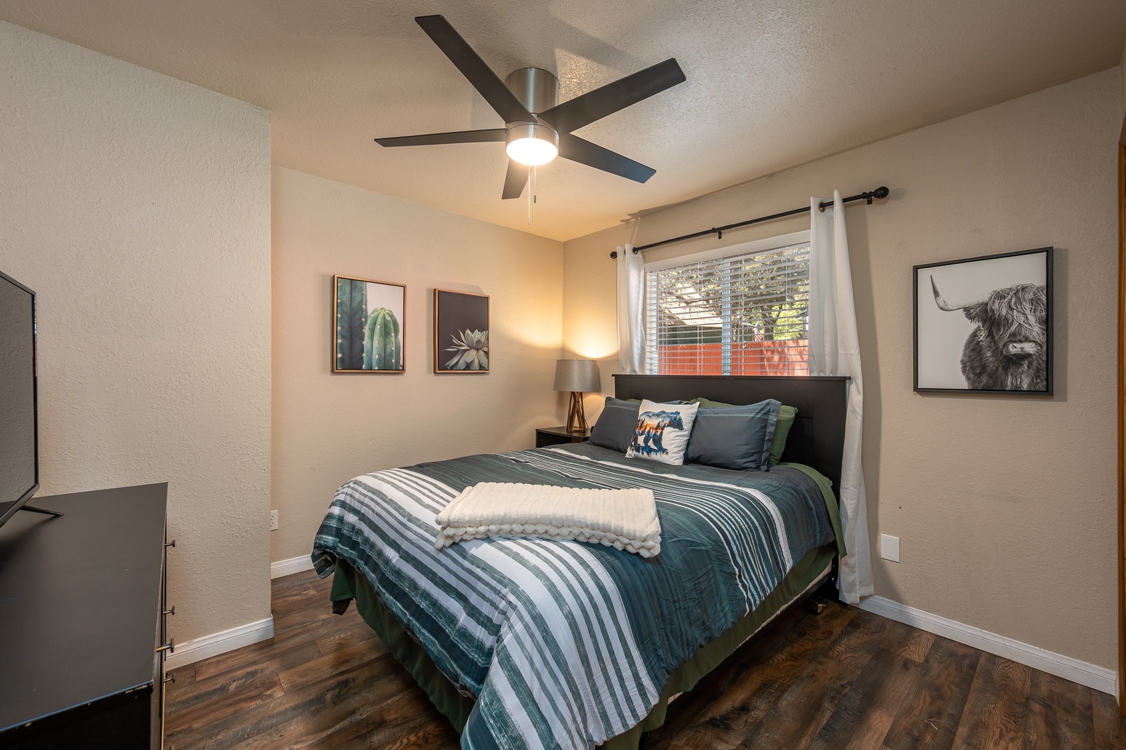 Your cozy bedroom features crisp linens, a peaceful sleeping space, and natural light streaming through the window, inviting restful nights after exploring nearby attractions.