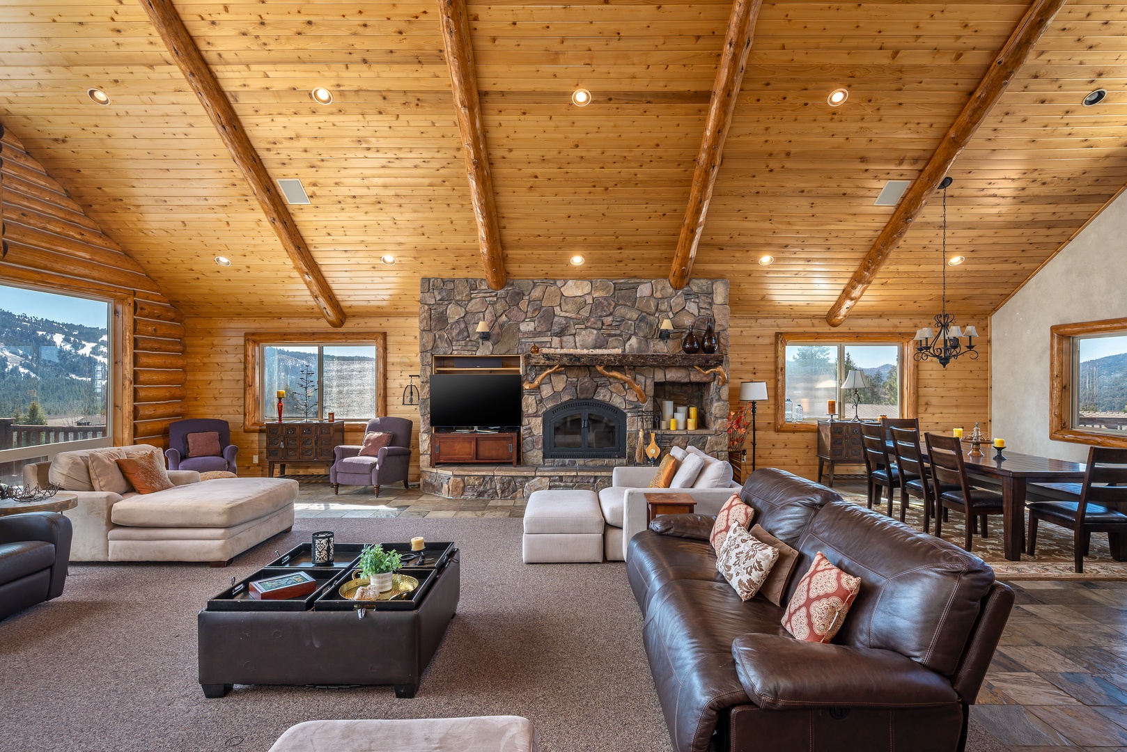 Gather around the stone fireplace in this spacious mountain lodge where rustic beams frame your perfect retreat moments.