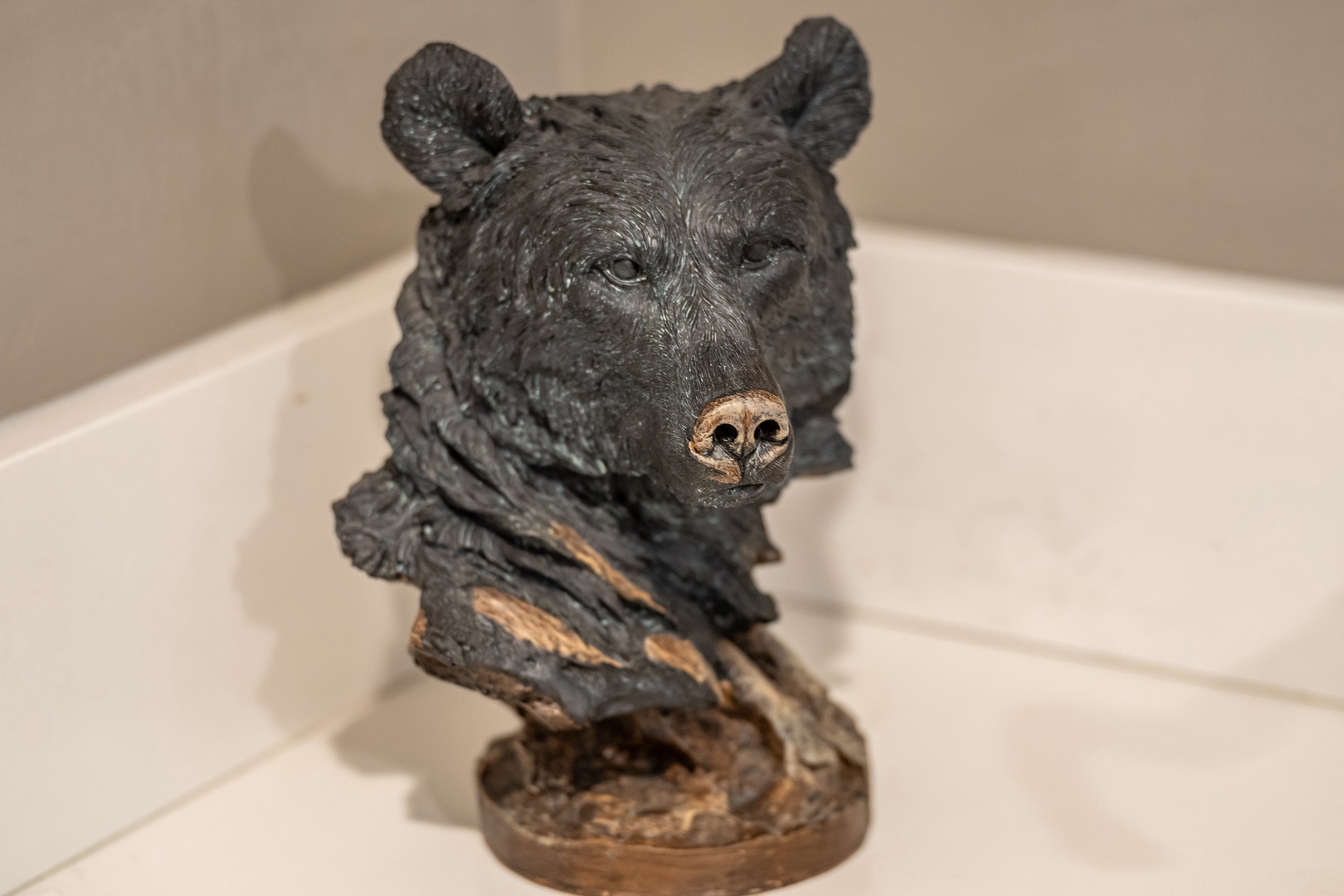 A charming bear sculpture adds rustic character to your bathroom, welcoming you with whimsical woodland charm each time you step inside.