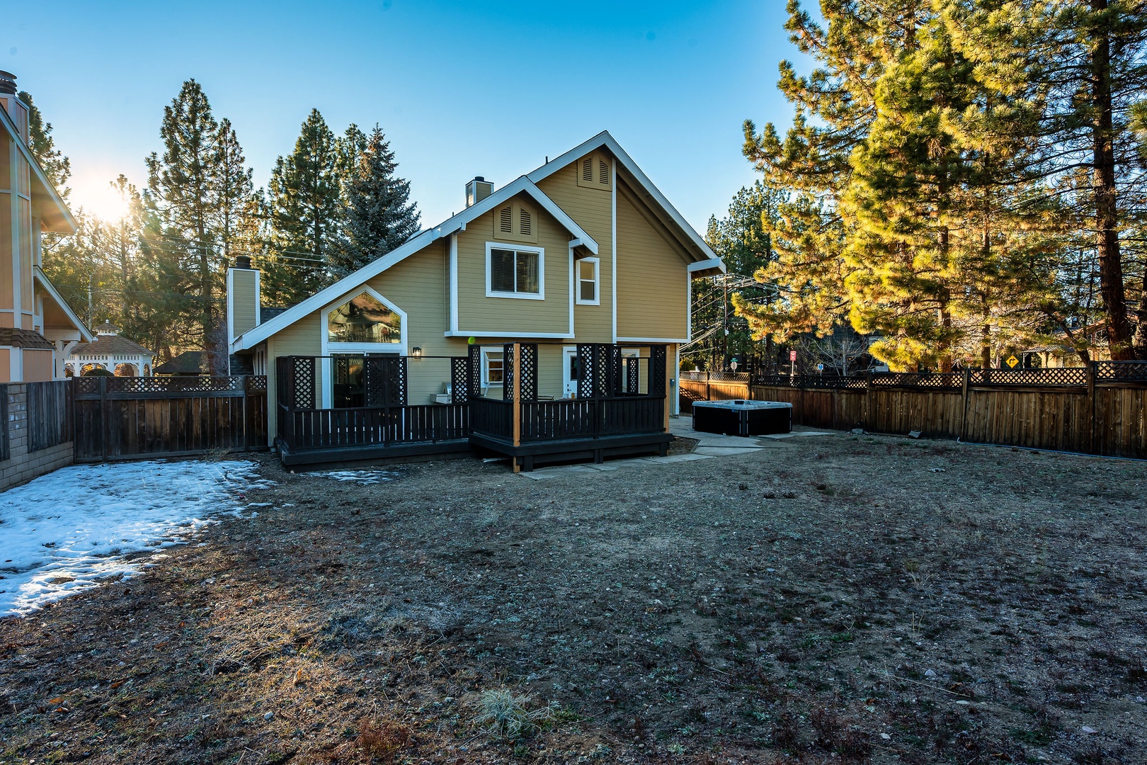 Charming mountain cabin nestled among tall pines with a spacious yard and hot tub, located in a peaceful wooded neighborhood.