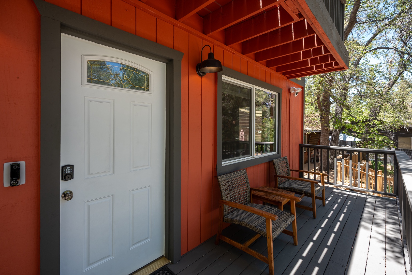 Your charming retreat greets you with a welcoming porch, complete with cozy seating where you can relax under the natural canopy and enjoy peaceful moments in the fresh mountain air.