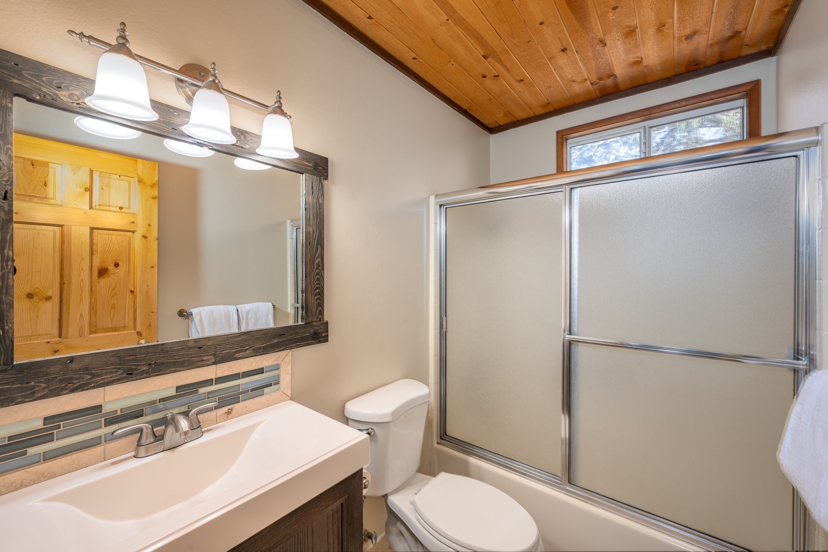 Refresh in your private bathroom featuring rustic wood accents, modern fixtures, and a spacious shower.