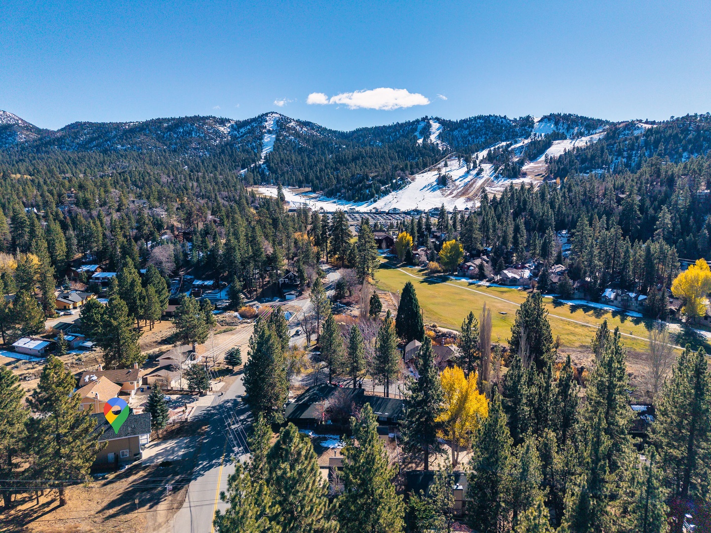 Aerial view of looking toward Bear Mountain Ski Resort and forested hills.