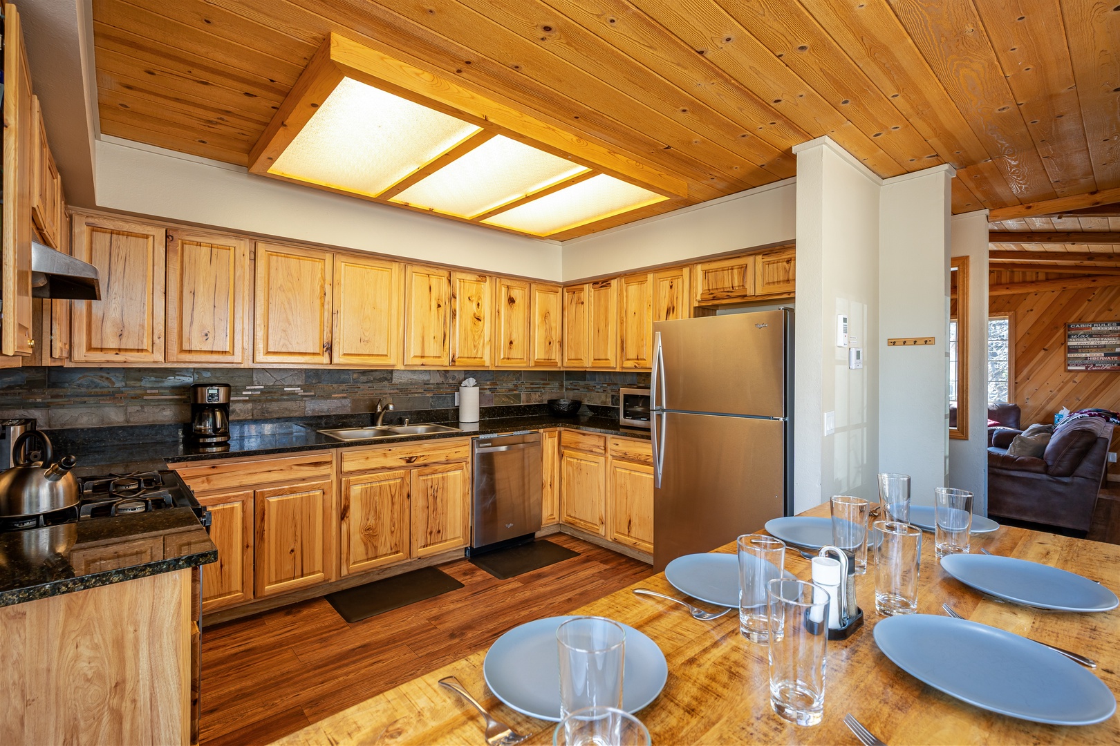 Your spacious mountain kitchen awaits with rich pine cabinetry, granite counters, and everything needed to create memorable meals together.