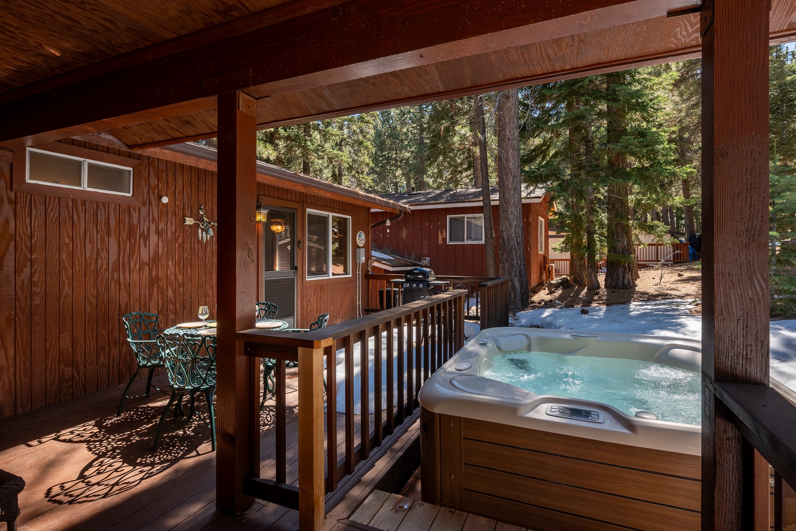 Unwind in your private hot tub under towering pines, where sunlight filters through the trees and relaxation awaits after your mountain adventures.