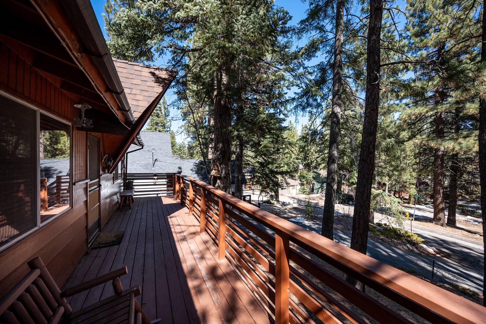 The cabin's spacious deck overlooks a peaceful, tree-lined neighborhood—a tranquil spot where you can sip your morning coffee surrounded by tall pines and fresh mountain air.