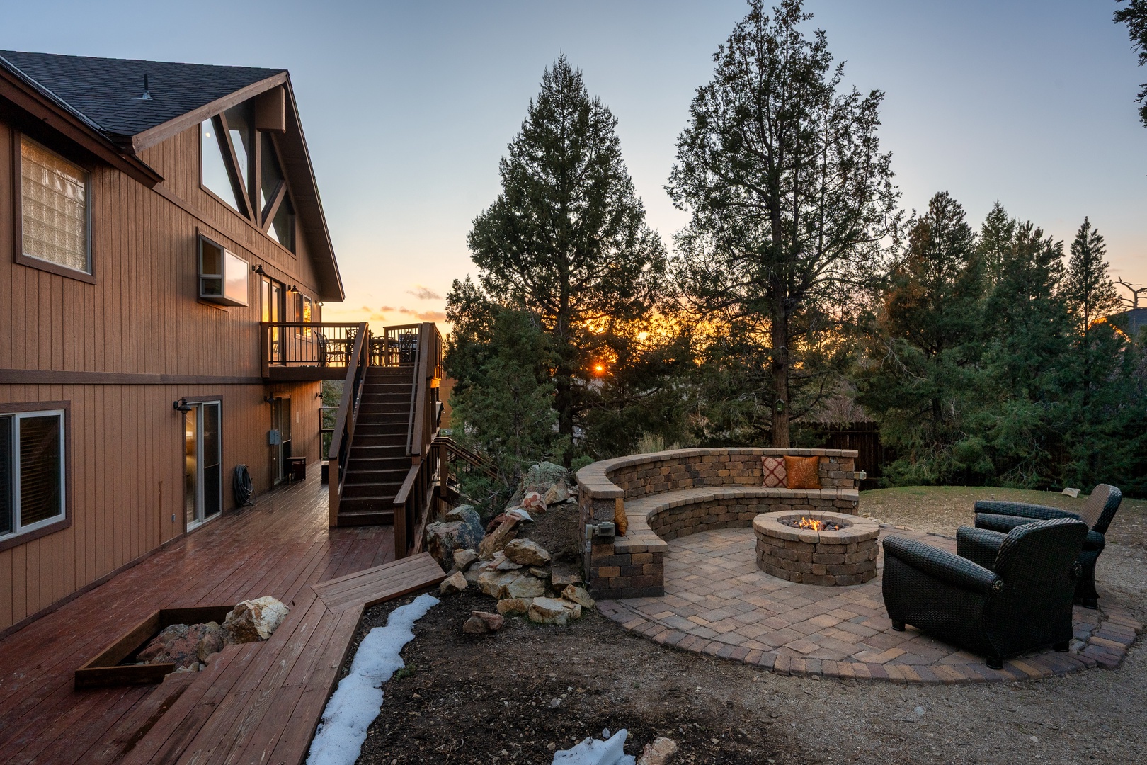 A mountain retreat with outdoor fire pit surrounded by forest, perfect for evening relaxation under the stars.