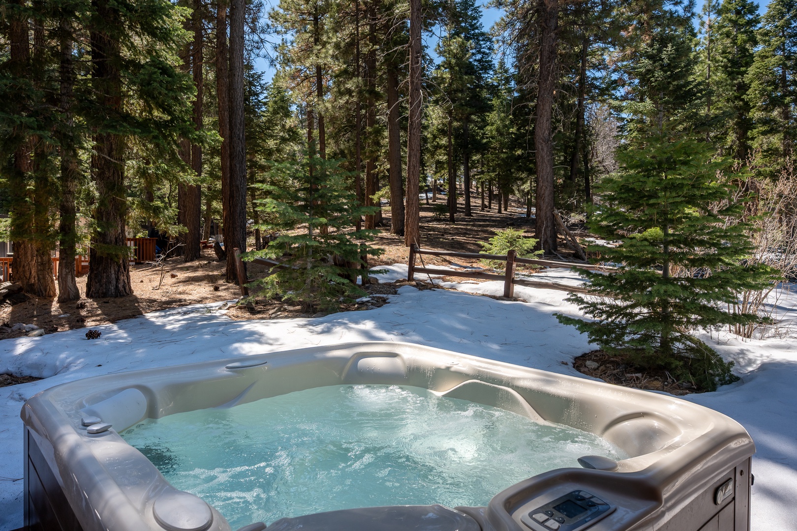 Soak in the bubbling hot tub surrounded by snow-dusted pines, where winter's magic creates your perfect mountain escape.