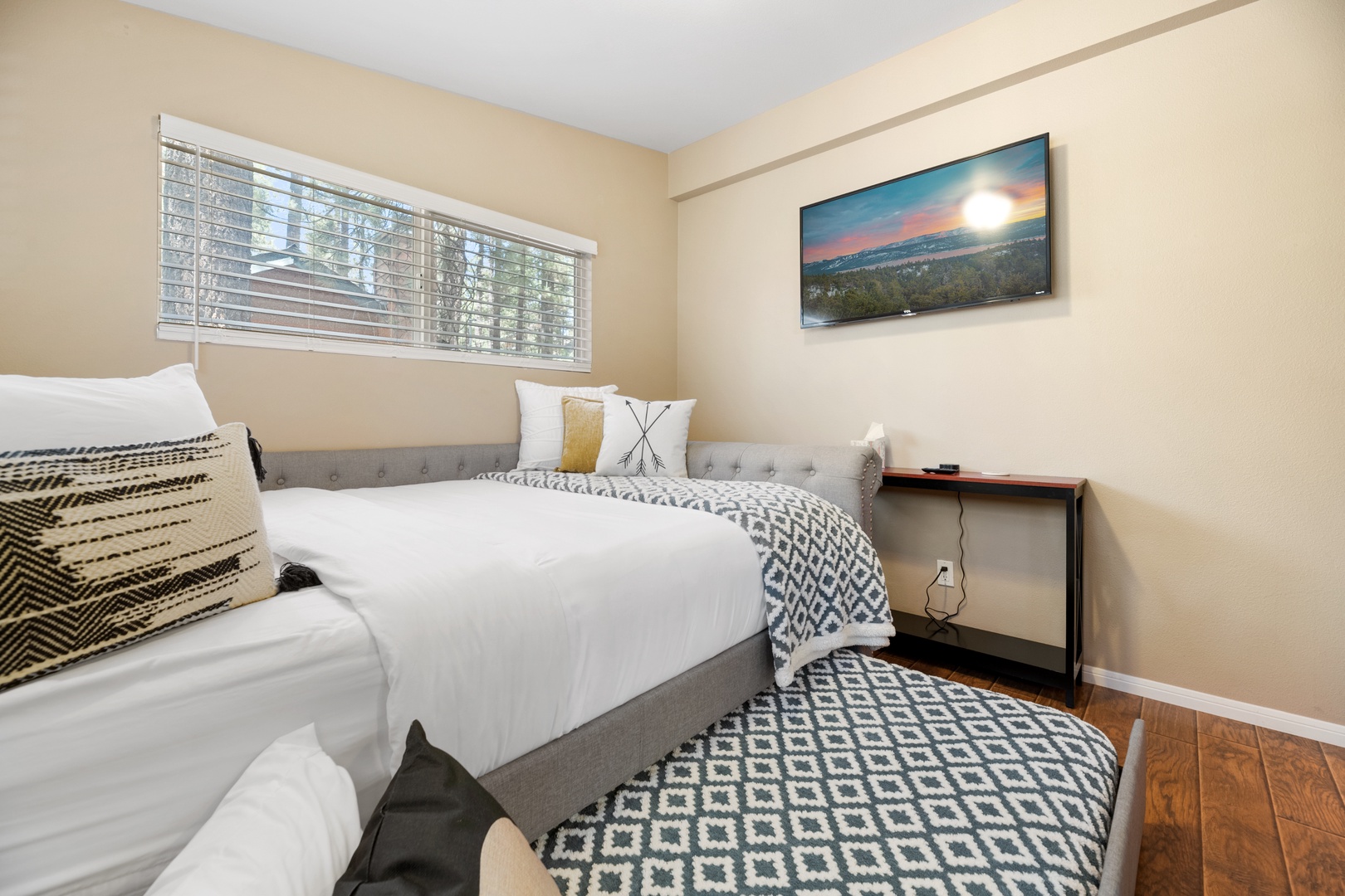 Sink into plush bedding and unwind in your serene bedroom, where natural light and thoughtful touches create the perfect retreat after a day of exploring.
