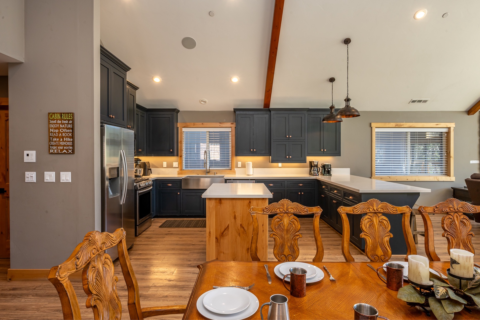 Gather around this spacious kitchen and dining area where your group can cook, share meals, and create memories together in a warm, inviting space.