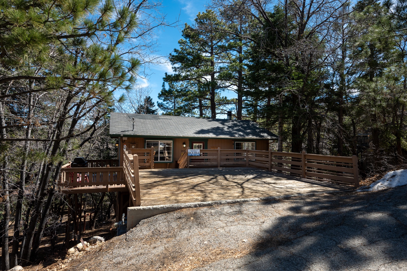 Charming mountain cabin nestled among towering pines with spacious wooden decks and serene forest surroundings.