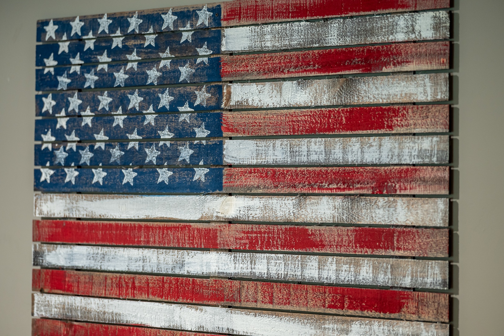 Rustic wooden American flag art piece adds patriotic character and handcrafted charm to your vacation space, creating a welcoming, homey atmosphere.
