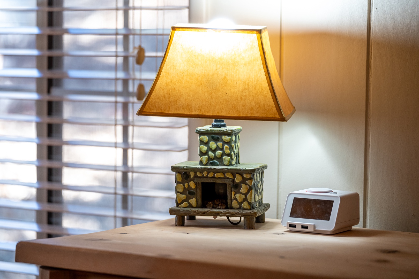 Cozy up with this charming decorative lamp and clock on your bedside table, creating the perfect ambiance for relaxing evenings.