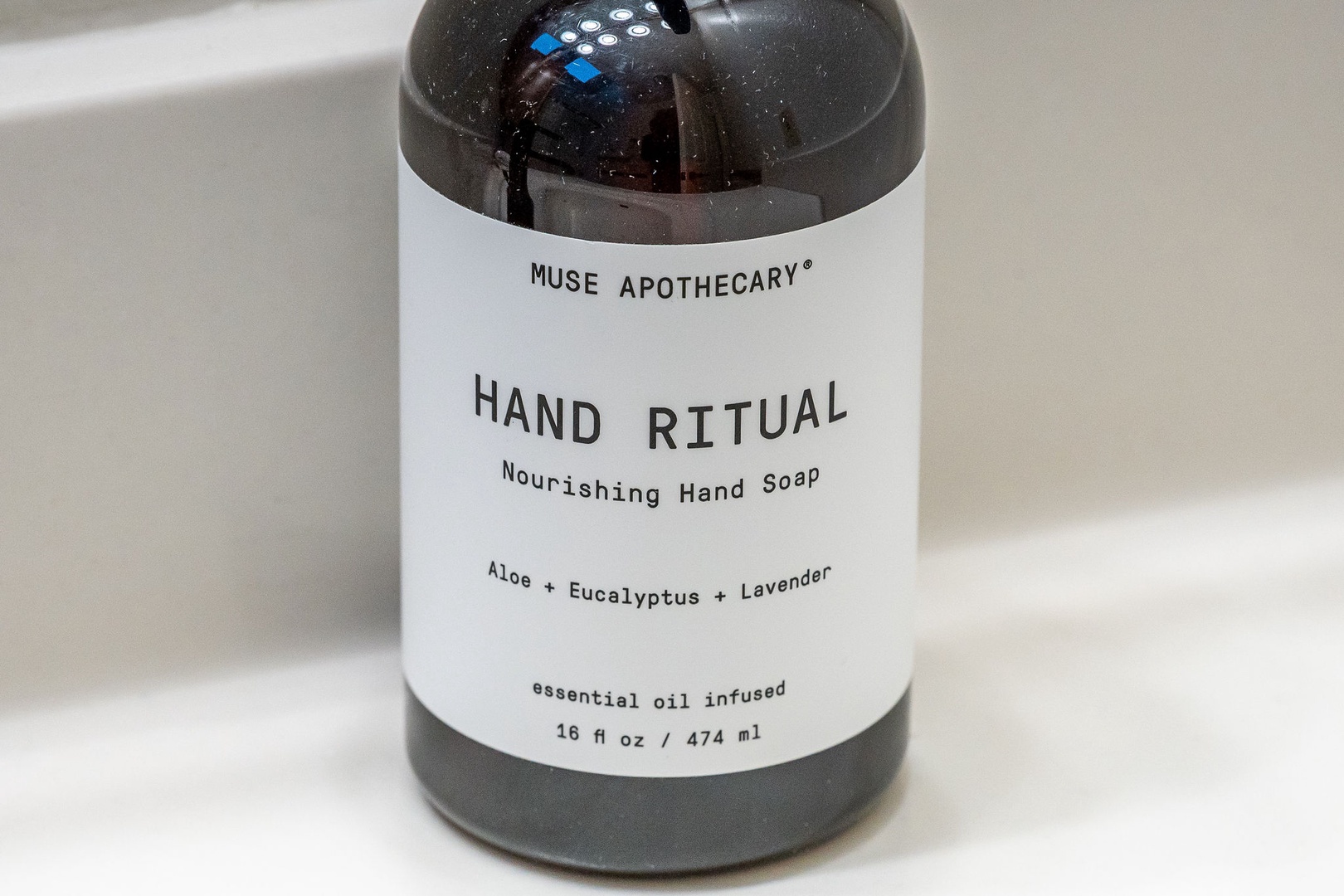 Premium hand soap with essential oils awaits in your bathroom for a luxurious cleansing experience.