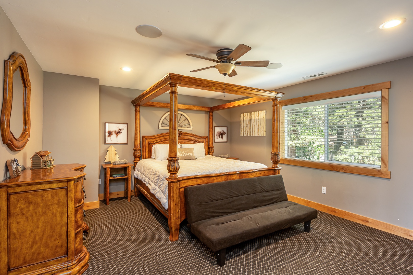 Unwind in this elegant bedroom featuring a handcrafted four-poster bed, soft lighting, and a tranquil natural view through your large window—your perfect retreat after a mountain adventure.