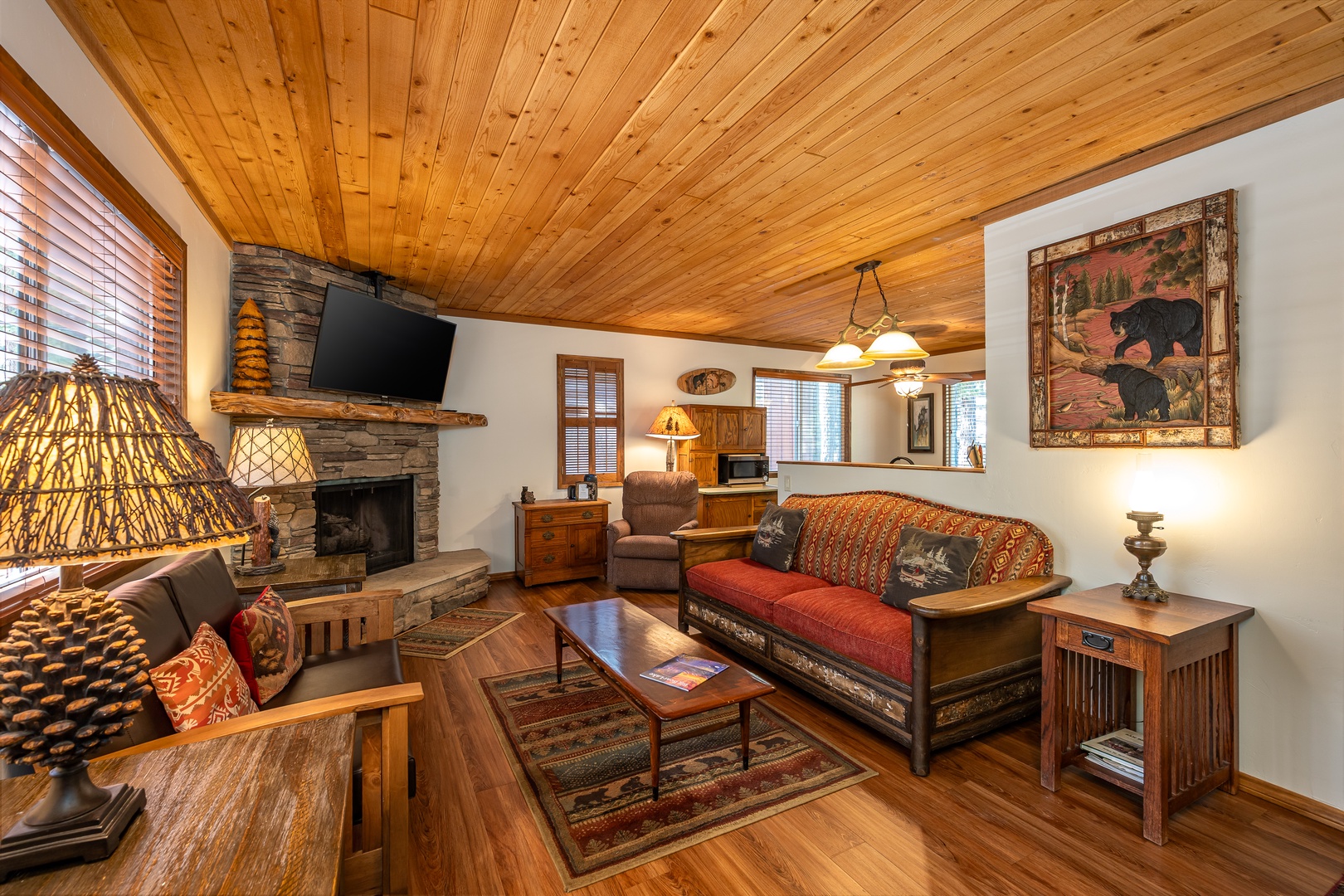 Cozy up in your rustic retreat with vaulted pine ceilings, a stone fireplace, and charming cabin décor. Sink into the inviting seating and feel instantly at home in this warm mountain escape.