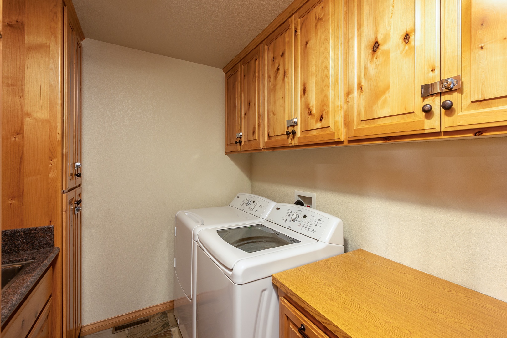 Your private laundry room features beautiful wood cabinetry and full-size washer and dryer for ultimate convenience.
