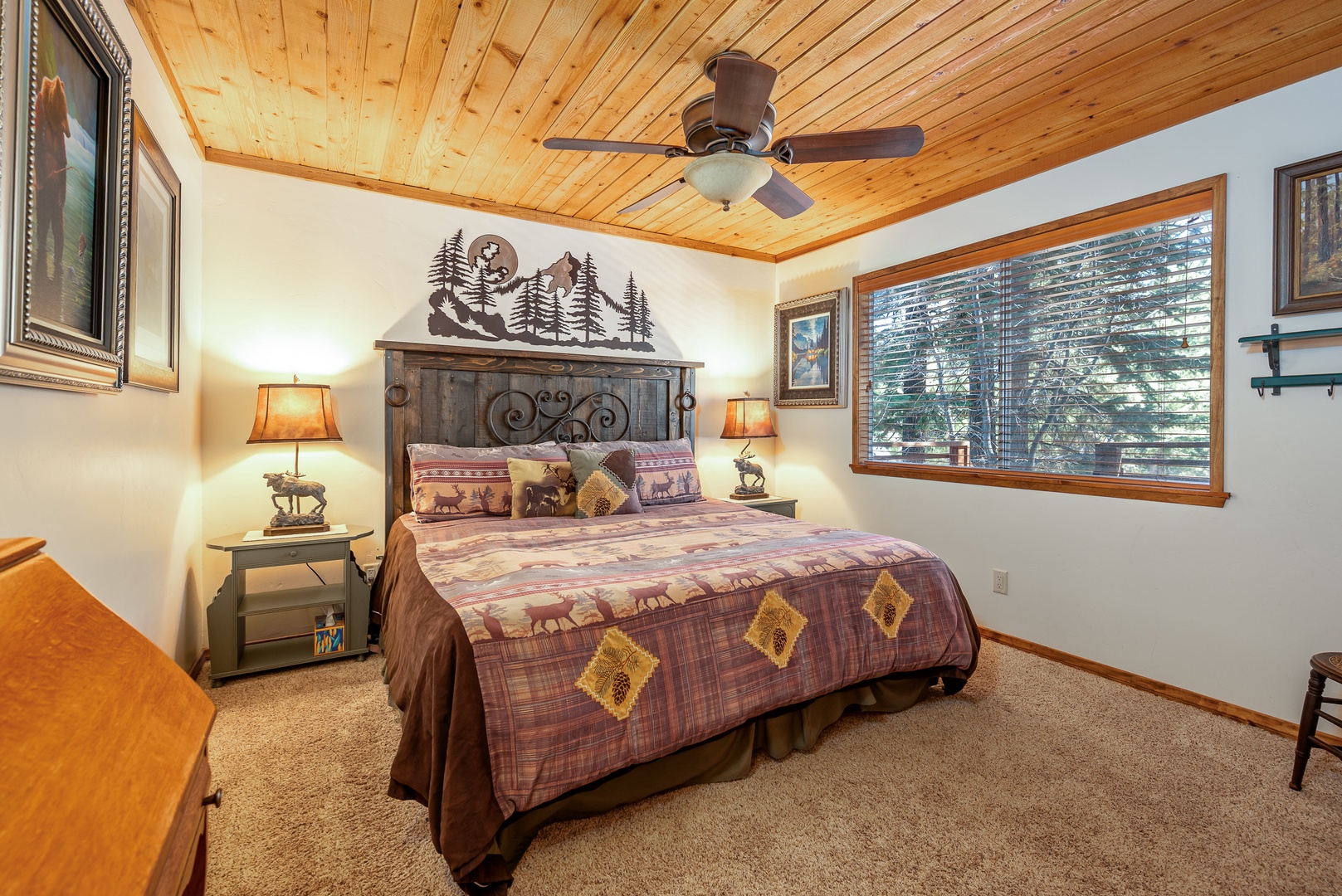 Drift off under soaring wood ceilings in this cozy retreat, where rustic charm meets forest comfort.