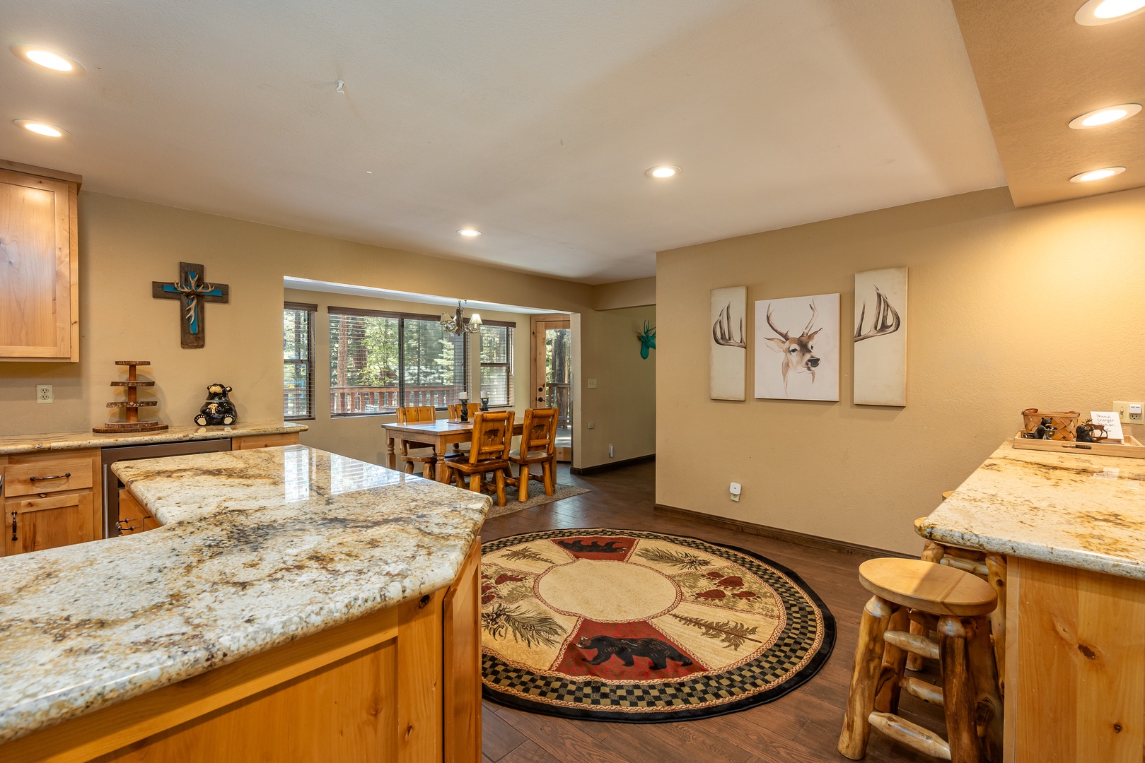 Picture yourself preparing meals on expansive granite countertops, gathering around the dining table, and enjoying mountain views through bright windows—all in this inviting, open-concept space designed for comfort and togetherness.