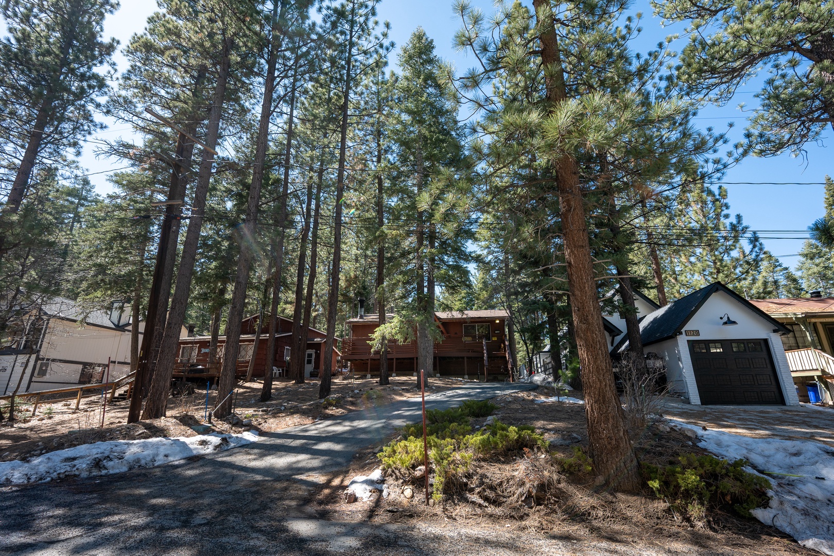 Nestled among towering pines, this mountain retreat offers peaceful woodland charm and easy access from your private driveway with garage parking.