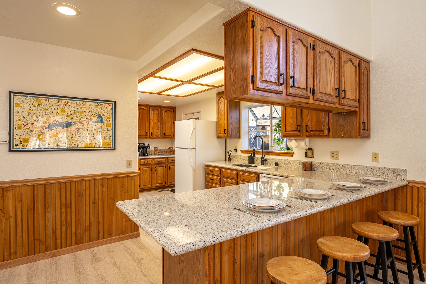Your fully equipped kitchen features granite countertops, and a breakfast bar for meals and conversation.