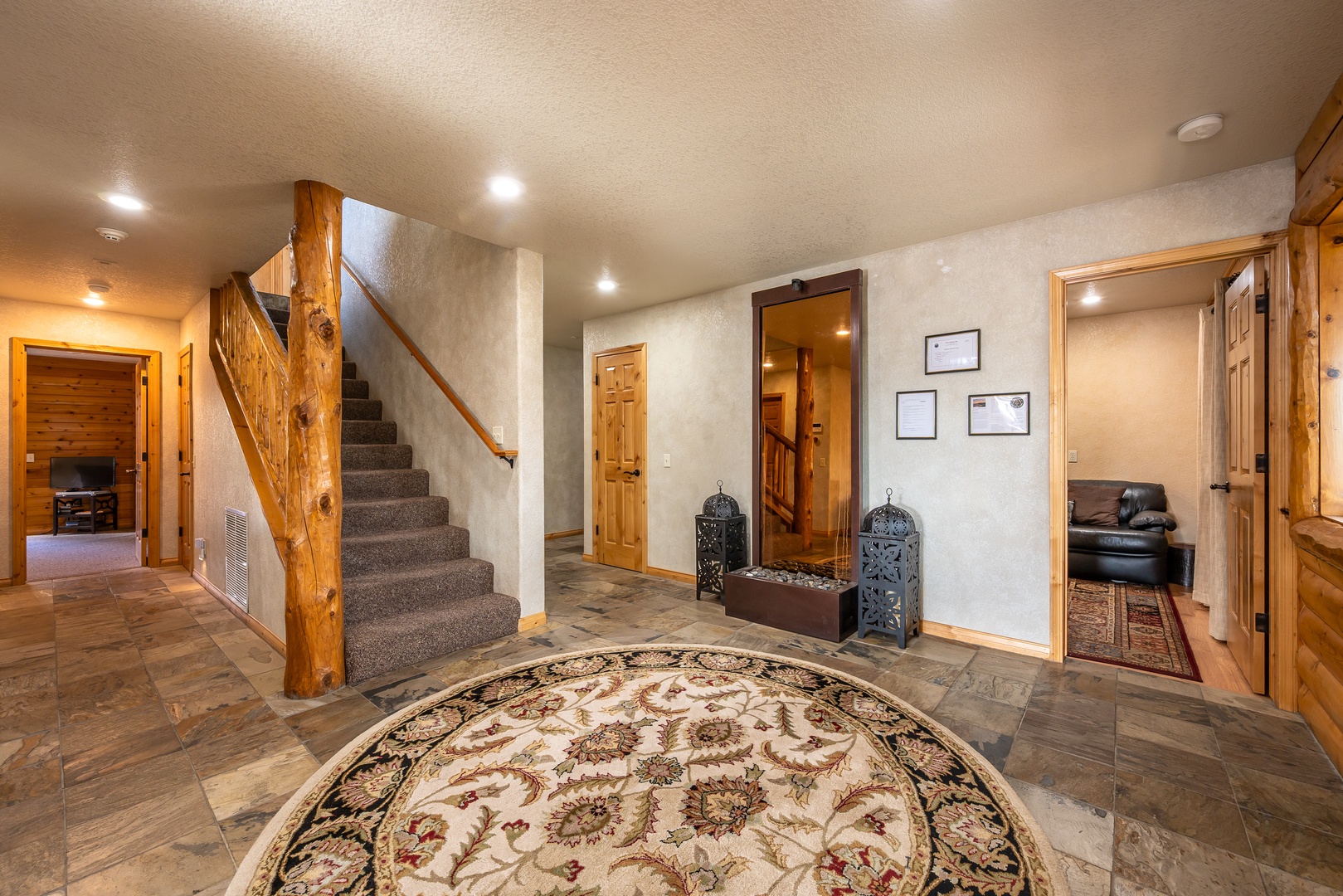 Step into your welcoming foyer where rustic wood beams and elegant touches create the perfect mountain retreat atmosphere.