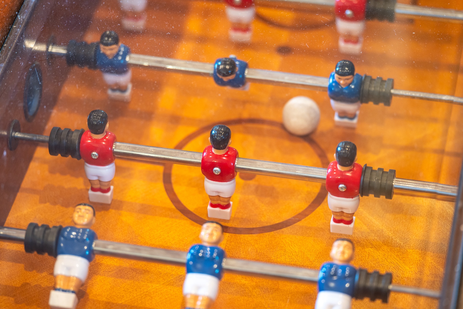 Challenge friends to spirited foosball matches in your game room, where red and blue teams battle for victory.