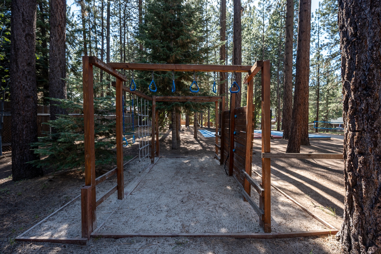 A peaceful playground nestled among towering pines, perfect for young adventurers to explore and enjoy the fresh mountain air.