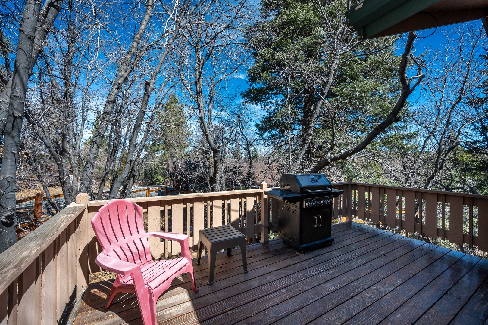 Step onto your private deck where a cozy chair awaits and the BBQ stands ready for outdoor cooking adventures.