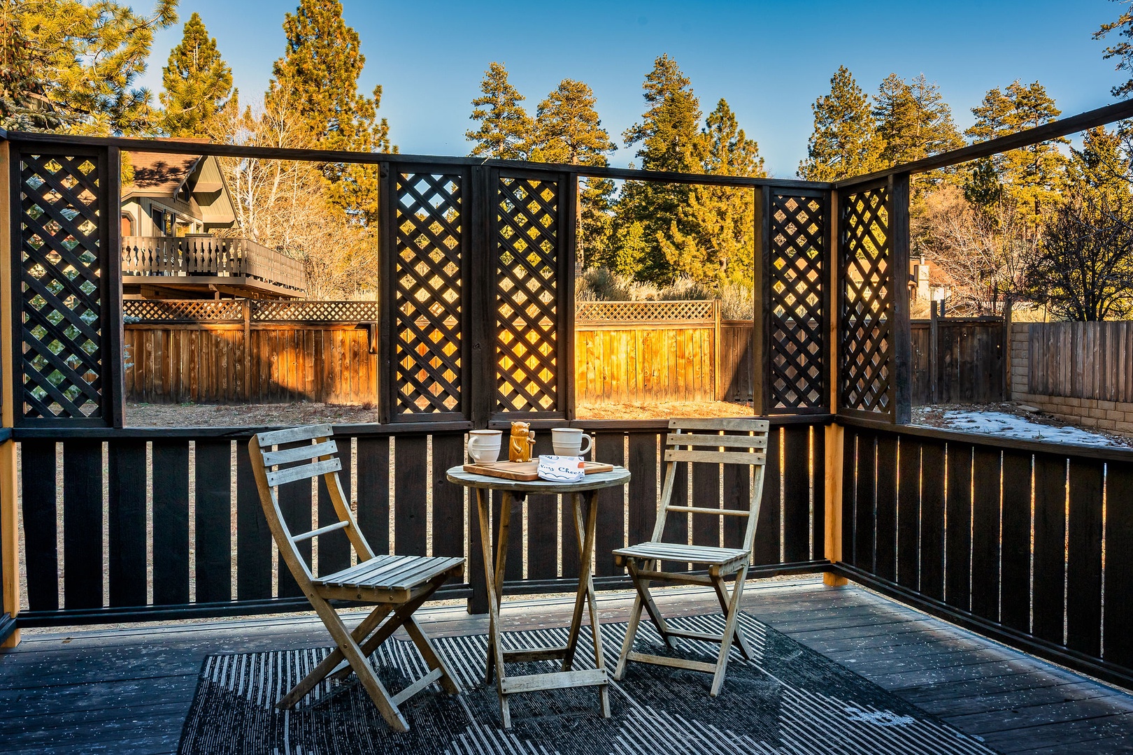 Step onto your private balcony and enjoy morning coffee at the bistro table, surrounded by decorative lattice screens and peaceful neighborhood views.